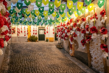 Festa dos Tabuleiros. in Tomar, Portugal. Street in the historic city center, decorated with banners and paper flowers.