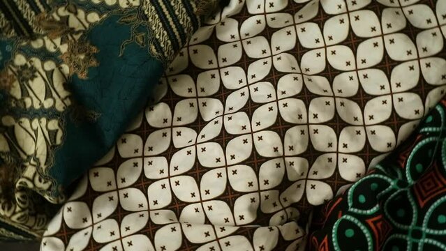 Spinning various motif of batic pattern fabric, Indonesia textured cloth background