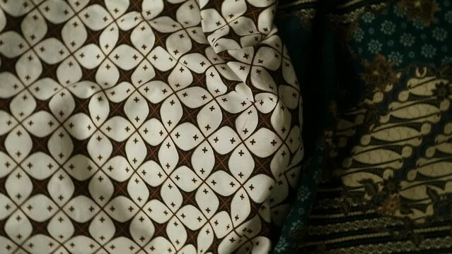 Spinning various motif of batic pattern fabric, Indonesia textured cloth background