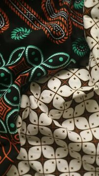 Spinning various motif of batic pattern fabric, Indonesia textured cloth background