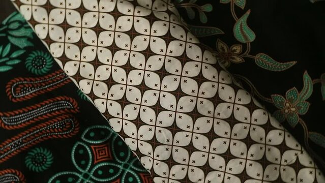 Spinning various motif of batic pattern fabric, Indonesia textured cloth background