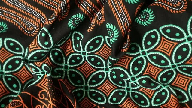 Spinning batik fabric, rotating textured unique pattern background, real time shoot