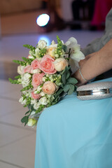 wedding bouquet of flowers, wedding bouquet of roses, close up bouquet, bouquet on woman's lap
