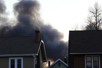 Smoke from a house fire in a residential community 