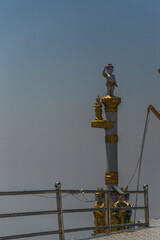 A statue of a man holding his hand up in the air