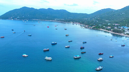 From the sky, witness the picturesque charm of numerous fishing boats adorning the breathtaking...