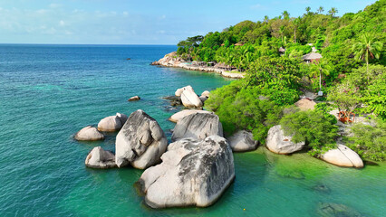 Majestic rocky cliffs embrace lush greenery overlooking the mesmerizing azure sea, a haven of...