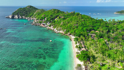 Enchanting sandy shore framed by lush greenery, adorned with a captivating resort, embraced by...
