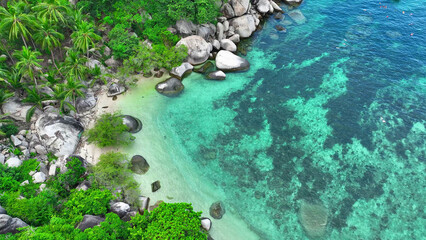 Bird's eye vista of a lush tropical isle, with rugged shores, a bustling ship, and snorkelers amid crystalline azure waters. Aerial view. Koh Nangyuan, Southern Thailand. Ocean background. 
