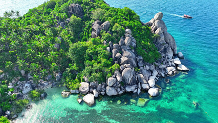 Verdant forests hug the coastline, where striking rock formations meet crystal-clear turquoise...