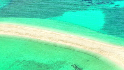 A serene sandbar, clear turquoise waters, aerial drone shot, peaceful shallow lagoon, unspoiled...