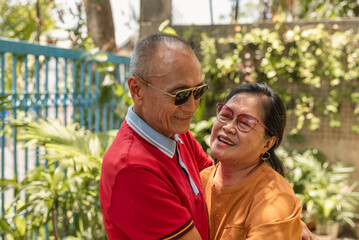 A old asian woman bonds with her long-time husband of 40 years. An affectionate and loving couple...