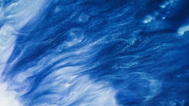 Fluid art drawing video, abstract acrylic texture with flowing effect. Liquid paint backdrop with chaotic waves and swirls. Artistic background motion with glitter and blue overflowing colors.