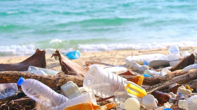 trash, plastic cups and plastic bags at the beach. environmental problem concept and healing the world