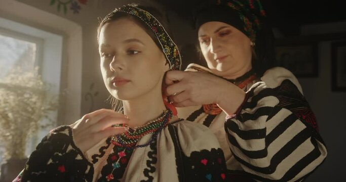 Intimate Moment of a Ukrainian Mother Adorning Her Daughter