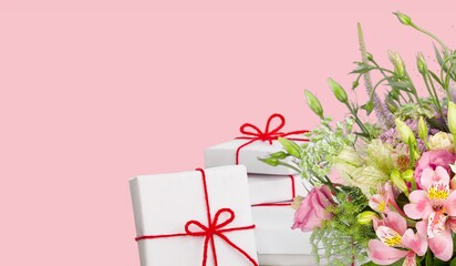 Mother's Day concept. giftbox with ribbon and bouquet of flowers