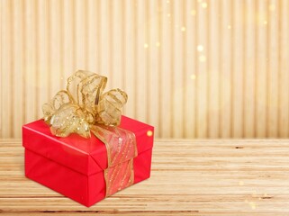 Red gift box with beautiful gold ribbon