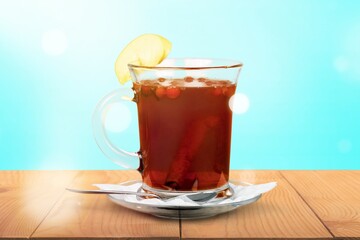 Tasty hot herbal tea in cup with lemon
