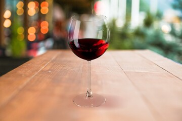 Red wine in glass on wooden desk