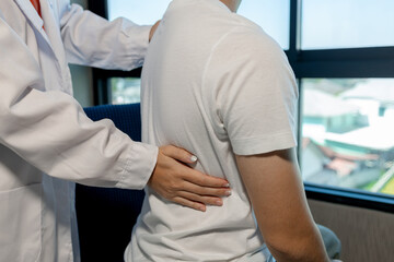 A physical therapist is helping a patient perform basic physical therapy stretches to relax the muscles, The physical therapy process takes place by experts in the physical therapy room.