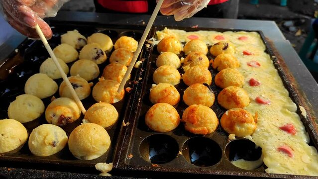 A Chef who is cooking Takoyaki.  Street food festival, Japanese street food.