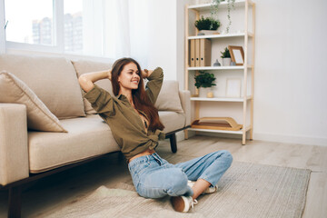 Home Comfort: Happy Woman Relaxing on a Cosy Sofa in Modern Apartment