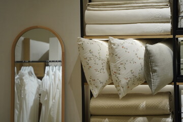 The pillows are neatly stacked on a rack in the dressing room.