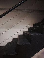 Black stairs for going up and down in a building.