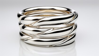 A series of polished silver stack rings with fine lily accents, arranged neatly on a sleek white surface for clean advertising