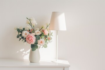 Minimalistic interior decor flower arrangement in a ceramic vase and white metal table lamp on a white table