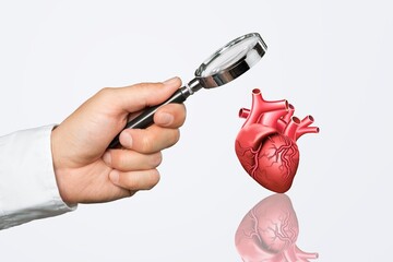 Doctor hand with magnifying glass with heart icon