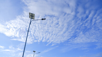Two Street Lights Against A Bright, Cloudy Blue Sky, At Tanjung Kalian, Muntok, Indonesia
