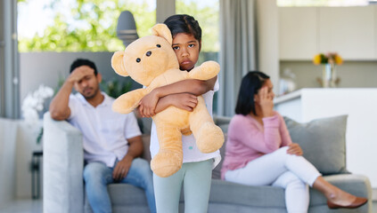 Couple, fighting and sad in child home, living room and girl with teddy bear for support and...