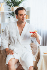 Beauty or body treatment spa salon vacation lifestyle concept with man wearing bathrobe relaxing...