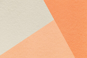 Texture of craft beige, coral and peach fuzz color paper background, macro. Vintage abstract cardboard