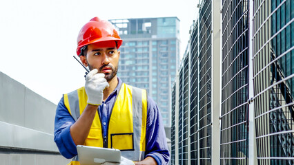 Asian male technical foreman inspects maintenance work holding a tablet and commands with talking...