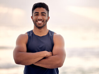 Portrait, arms crossed and man for beach fitness, muscle and strong with biceps, health and...