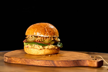 Indulge in a deluxe burger crafted from savory beef, molten cheese, and artisanal bun. A culinary masterpiece, tempting and irresistible.