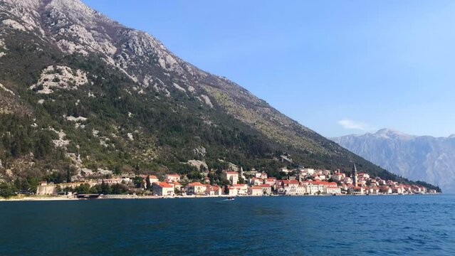 Boat sailing to the historic town of Perast in the Bay of Kotor. Adriatic Sea. Perast, Montenegro. Europe.