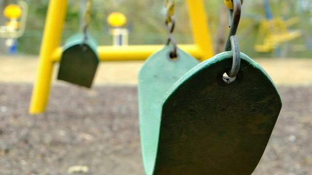 empty swing moving in slow motion