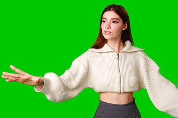 Young Woman in White Hoodie Gesturing Upwards on Green Screen Background