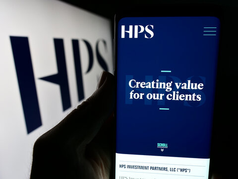 Stuttgart, Germany - 04-13-2024: Person holding mobile phone with website of US company HPS Investment Partners LLC in front of logo. Focus on center of phone display.