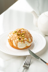 Cinnamon roll bun with icing on plate