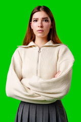 Young Woman With Arms Crossed Standing Against Green Background