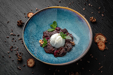 Dessert broken brownies with ice cream. Menu for a pub on a dark background. Colorful juicy food...