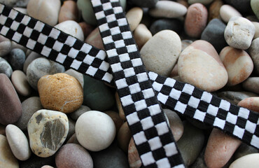 Fabric Crisscross Racing Checkered Stripe On Decorative Rocks Closeup View
