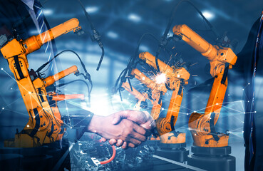 MLB Mechanized industry robot arm and business handshake double exposure. Concept of successful...