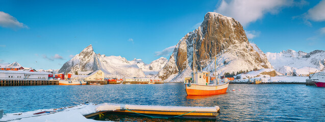 Gorgeous winter view on Hamnoy village with port and Festhaeltinden and Olstinden peaks on...