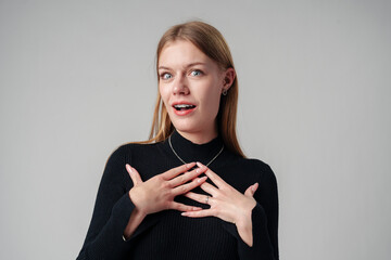 Young Woman Holding Hands Together in Black Shirt in studio