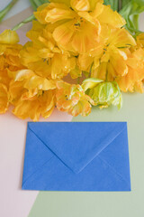 Blue envelope letter and yellow flowers